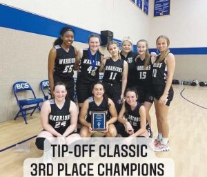 Lady Warriors pose for a photo with their plaque after taking 3rd place at the Tip-Off Classic in Fort Worth. Kayla Buchanan